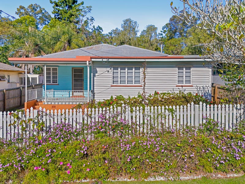 Front of 68 Fernvale Rd, Brassall: a Queenslander-style home behind a white picket fence
